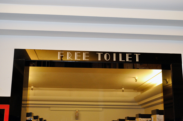 Free toilet sign in downtown Minneapolis Macy's 4th floor bathroom.